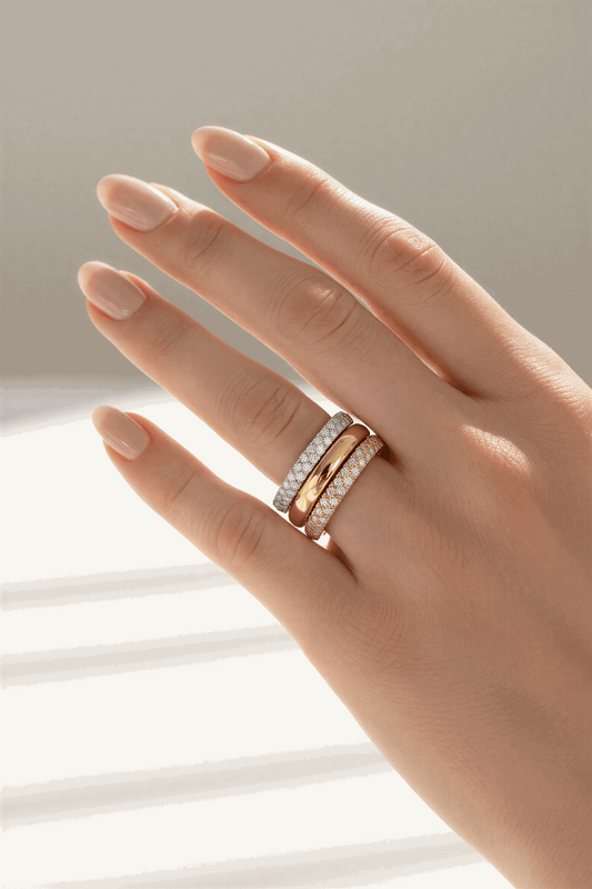 Gold ring with diamond accents on a woman's finger.