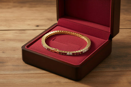 Gold bracelet with red and white stones in a velvet jewelry box