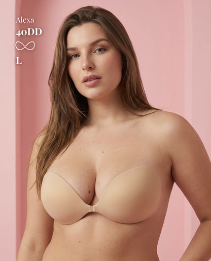 Standing model wearing the beige Sticky Bra in Large with a fastened front clasp, labeled 40DD.