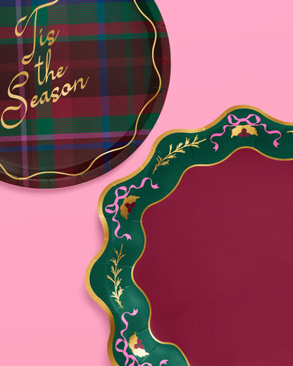 Two decorative plates with plaid and ornate designs on a pink background