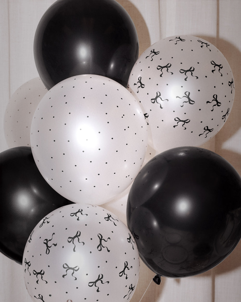 Black and white balloons with patterns on a wooden background
