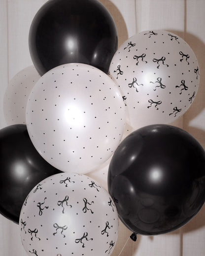 Black and white balloons with patterns on a wooden background