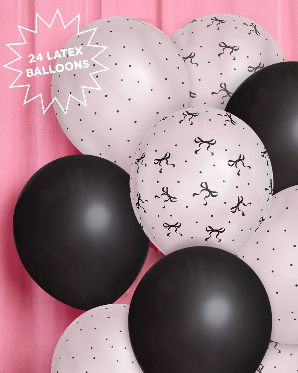 Black and white balloons with bow patterns on a pink background