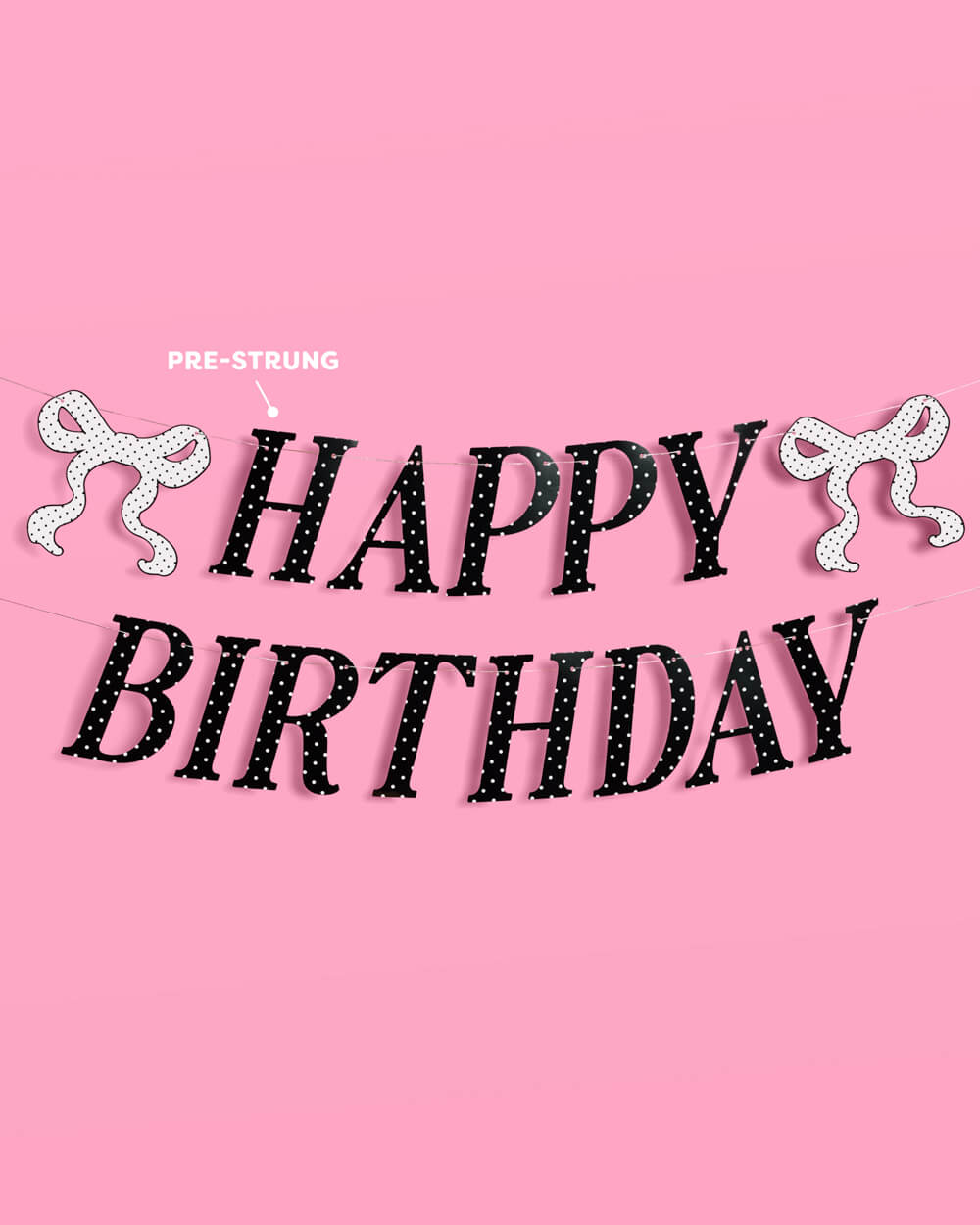 Happy Birthday banner with decorative ribbons on a pink background