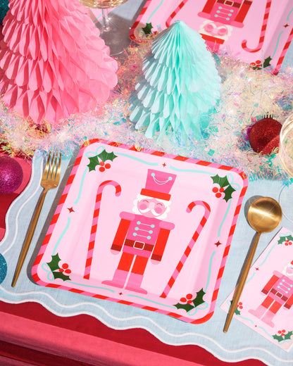 Christmas-themed placemat with nutcracker design on a festive table setting.