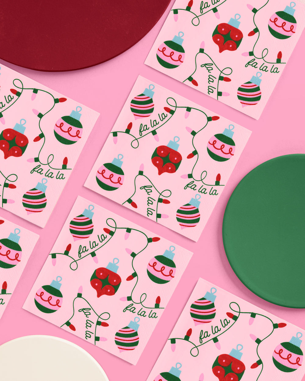Christmas-themed stickers with ornaments and 'fa la la' text on pink paper.