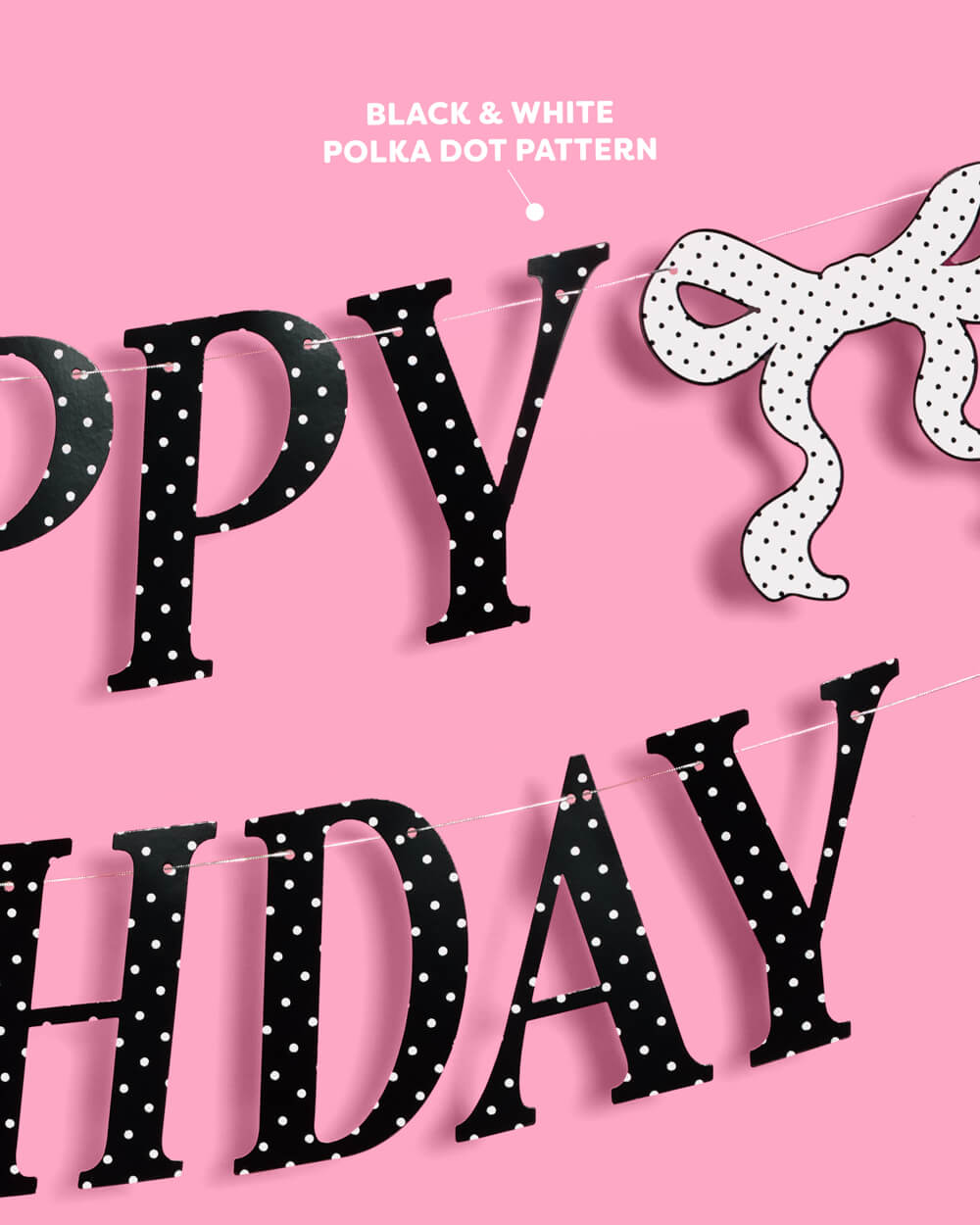 Black polka dot 'Happy Birthday' banner on a pink background