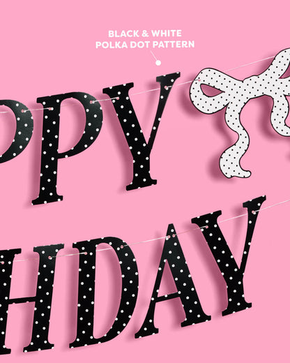 Black polka dot 'Happy Birthday' banner on a pink background