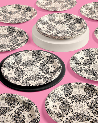 Black and white patterned plates on a pink background