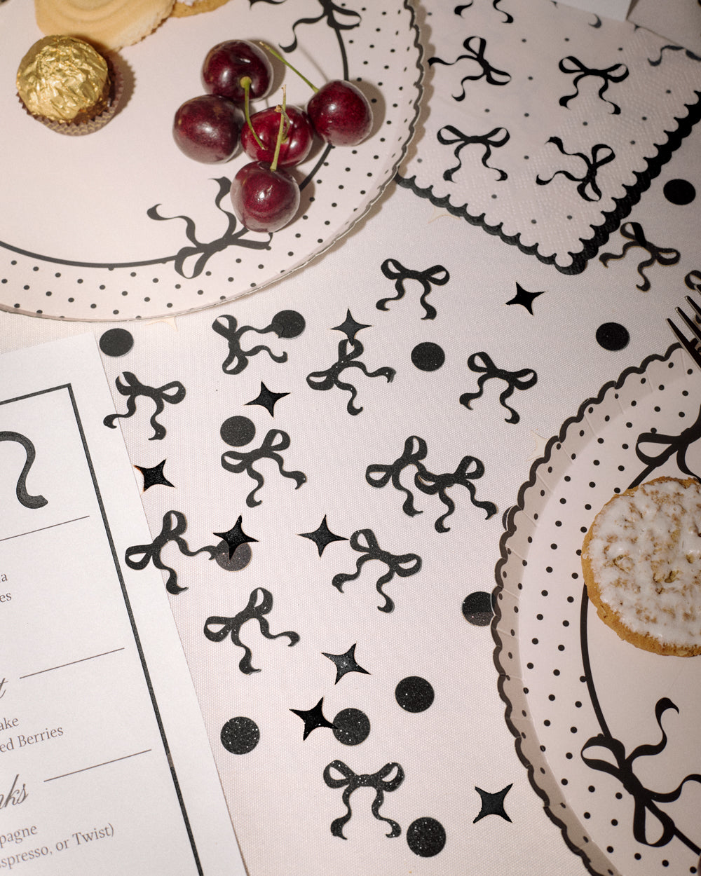 Black decorative elements on a white surface with food items in the background
