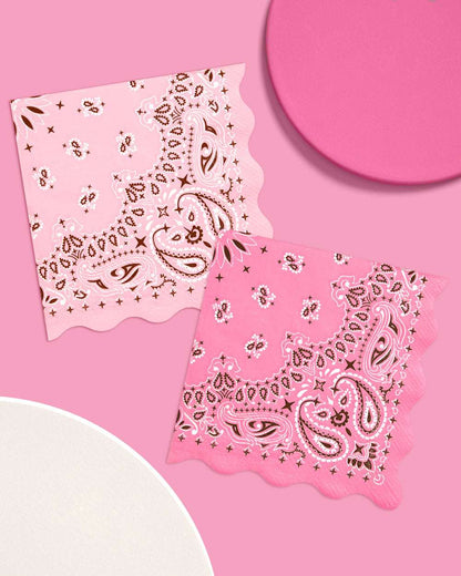 Two pink bandanas with paisley patterns on a pink background