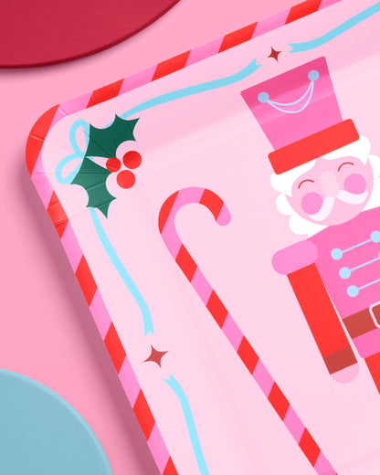 Two Christmas-themed greeting cards with candy cane and Santa Claus designs on a pink background.