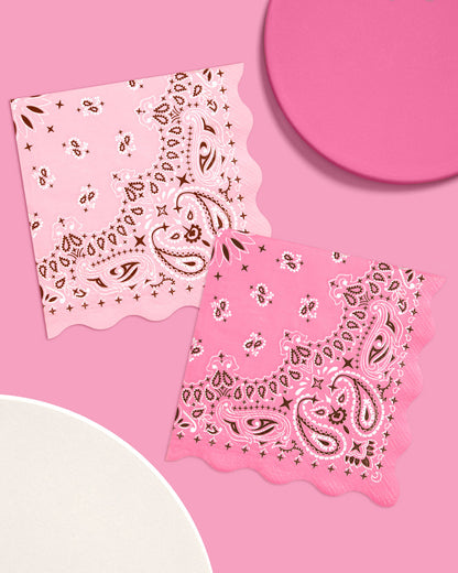 Two pink bandanas with paisley patterns on a pink background