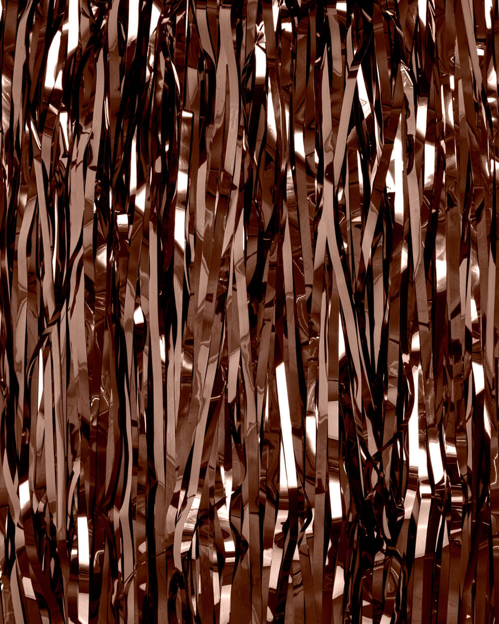 Rose gold tinsel strands against a dark background