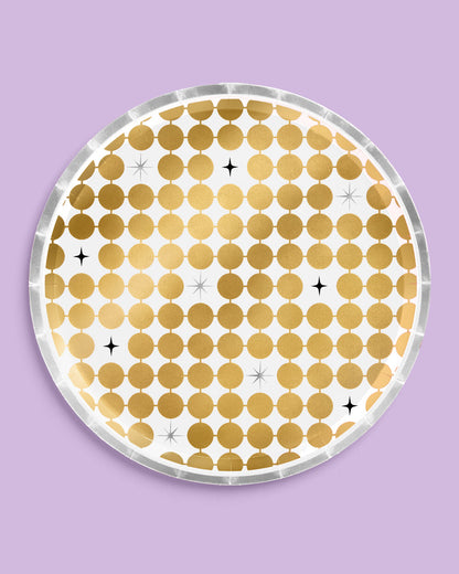 Round gold polka dot coaster on a purple background