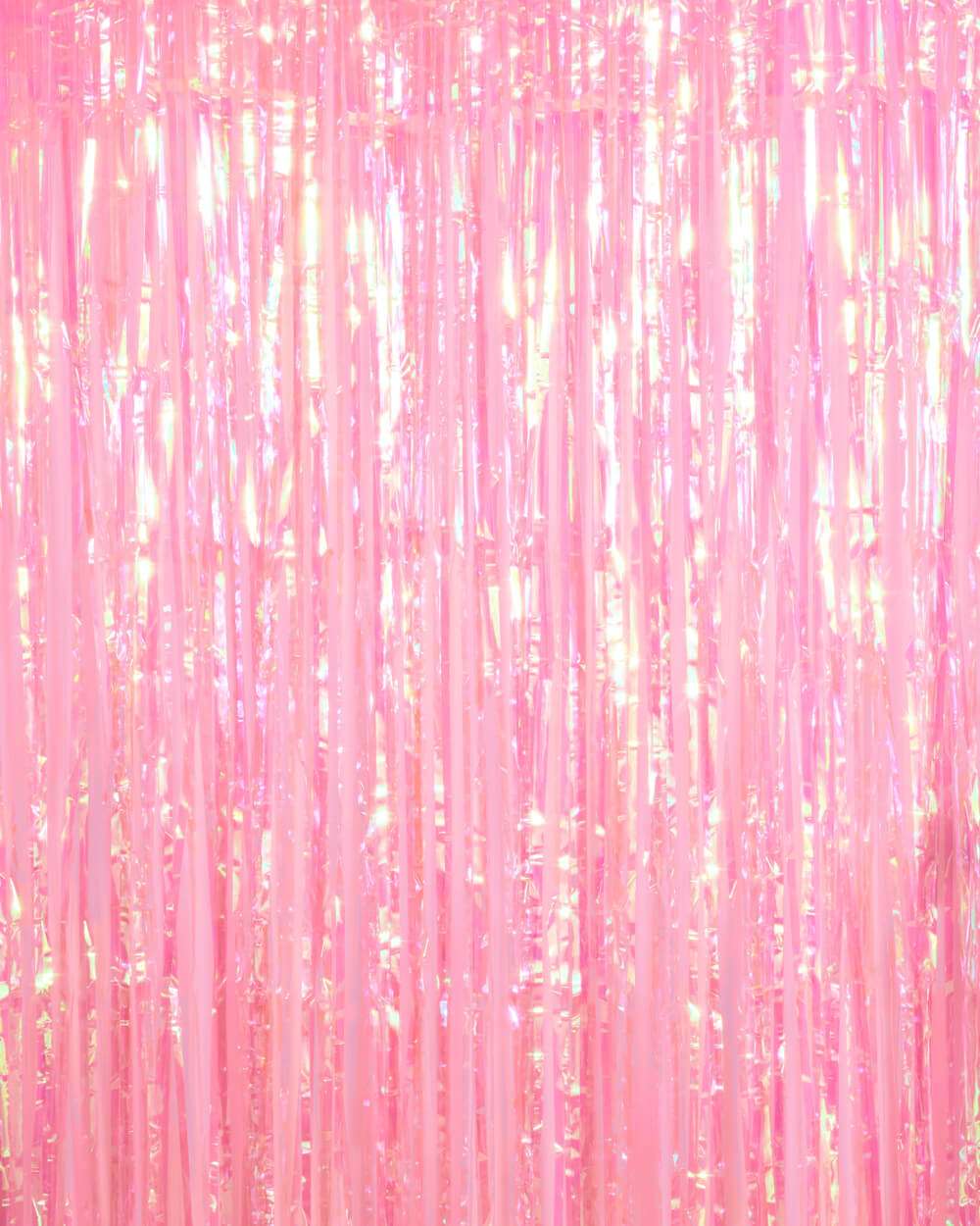 Shimmering pink plastic fringe curtain with iridescent metallic finish and vertical tinsel strands.