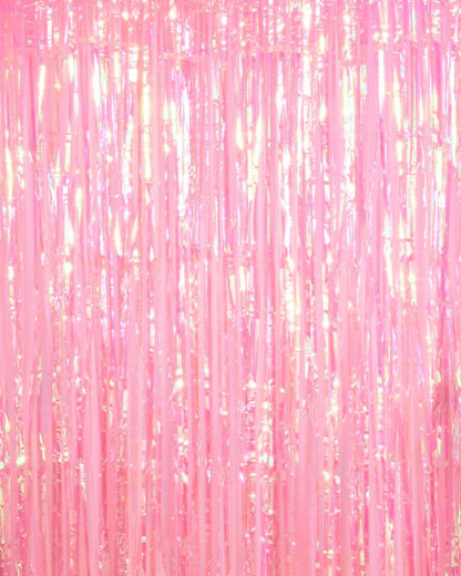 Shimmering pink plastic fringe curtain with iridescent metallic finish and vertical tinsel strands.