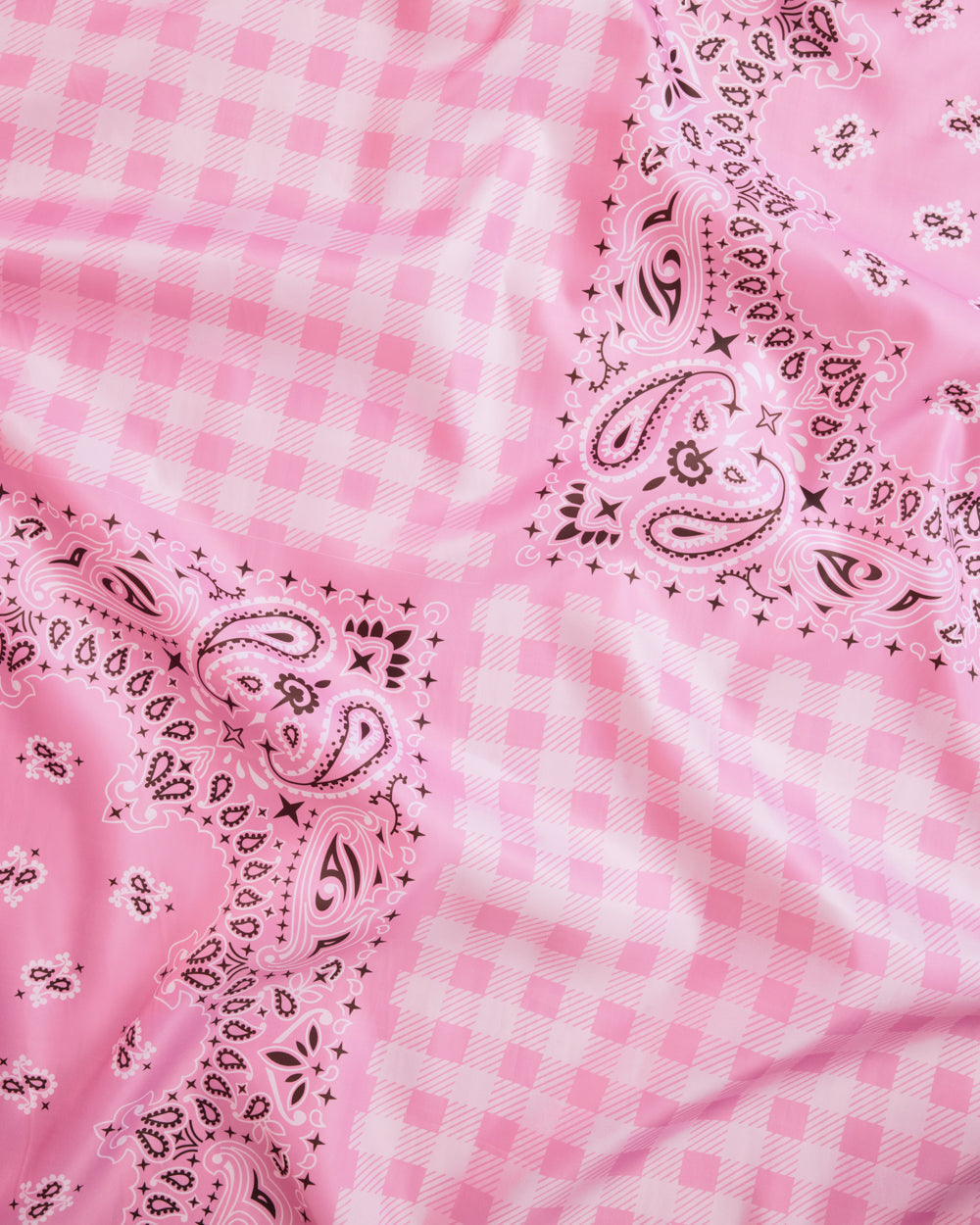 Pink checkered fabric with paisley patterns