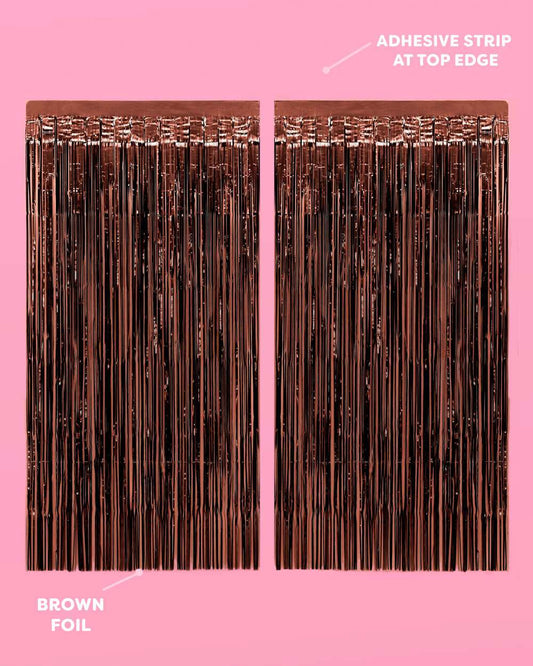 Brown foil strip with adhesive strip at top edge on a pink background