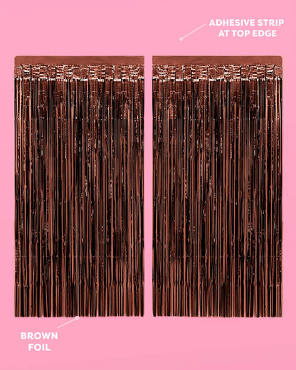 Brown foil strip with adhesive strip at top edge on a pink background