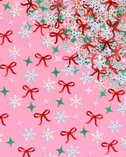 Christmas-themed pattern with bows, snowflakes, and stars on a pink background