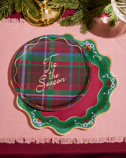 Plaid plate with 'Tis the Season' text on a pink tablecloth