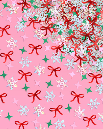 Christmas-themed pattern with bows, snowflakes, and stars on a pink background