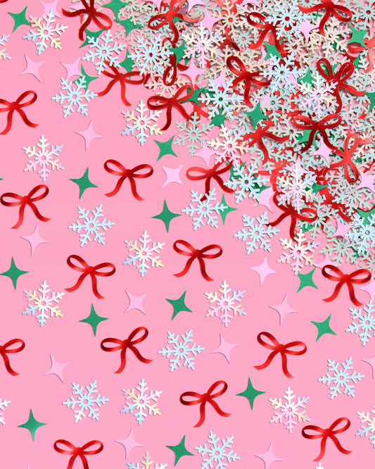 Christmas-themed pattern with bows, snowflakes, and stars on a pink background