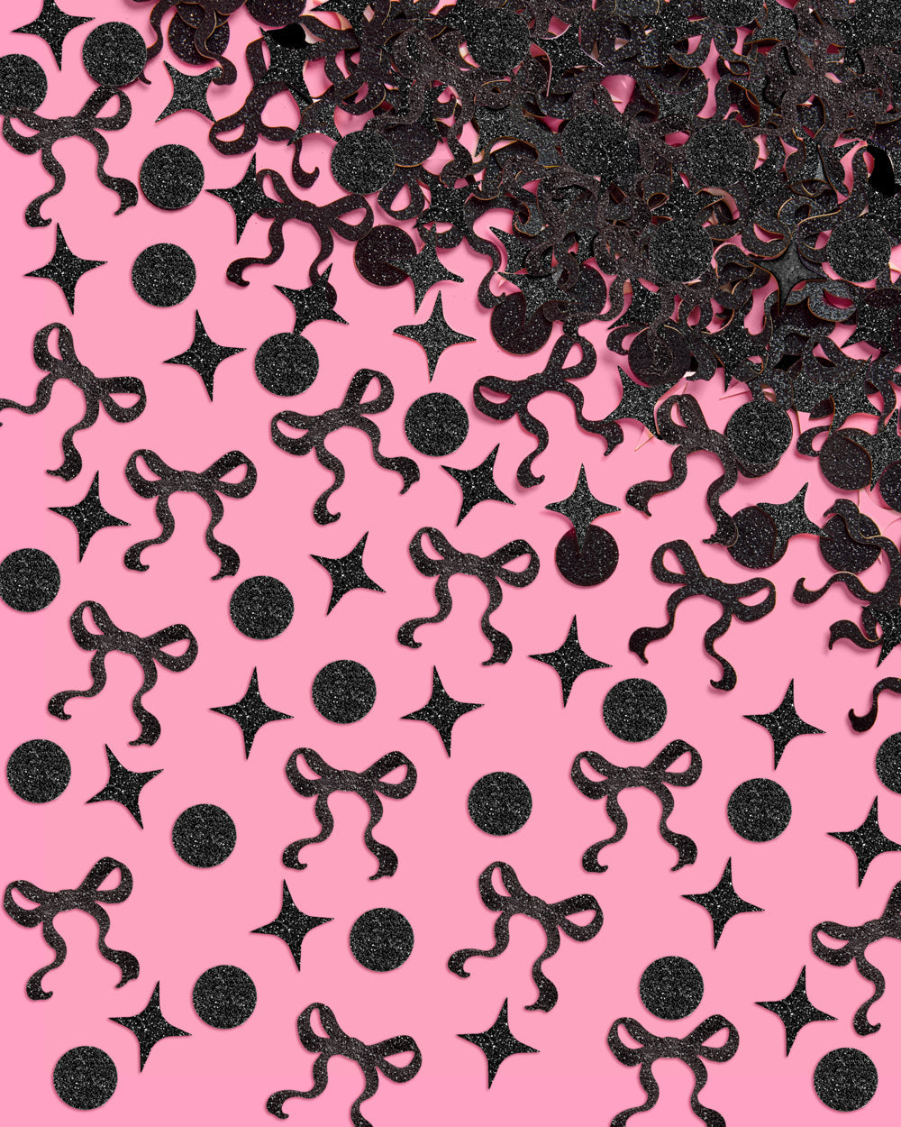 Black decorative confetti shapes on a pink background