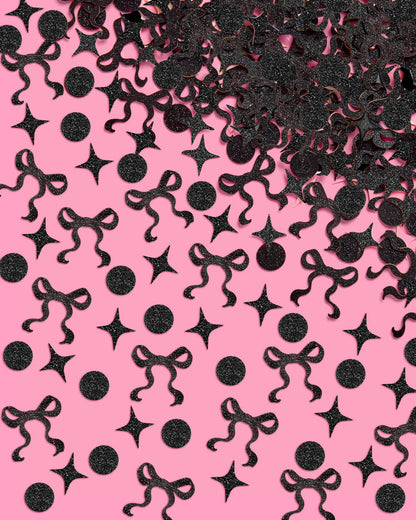 Black decorative confetti shapes on a pink background