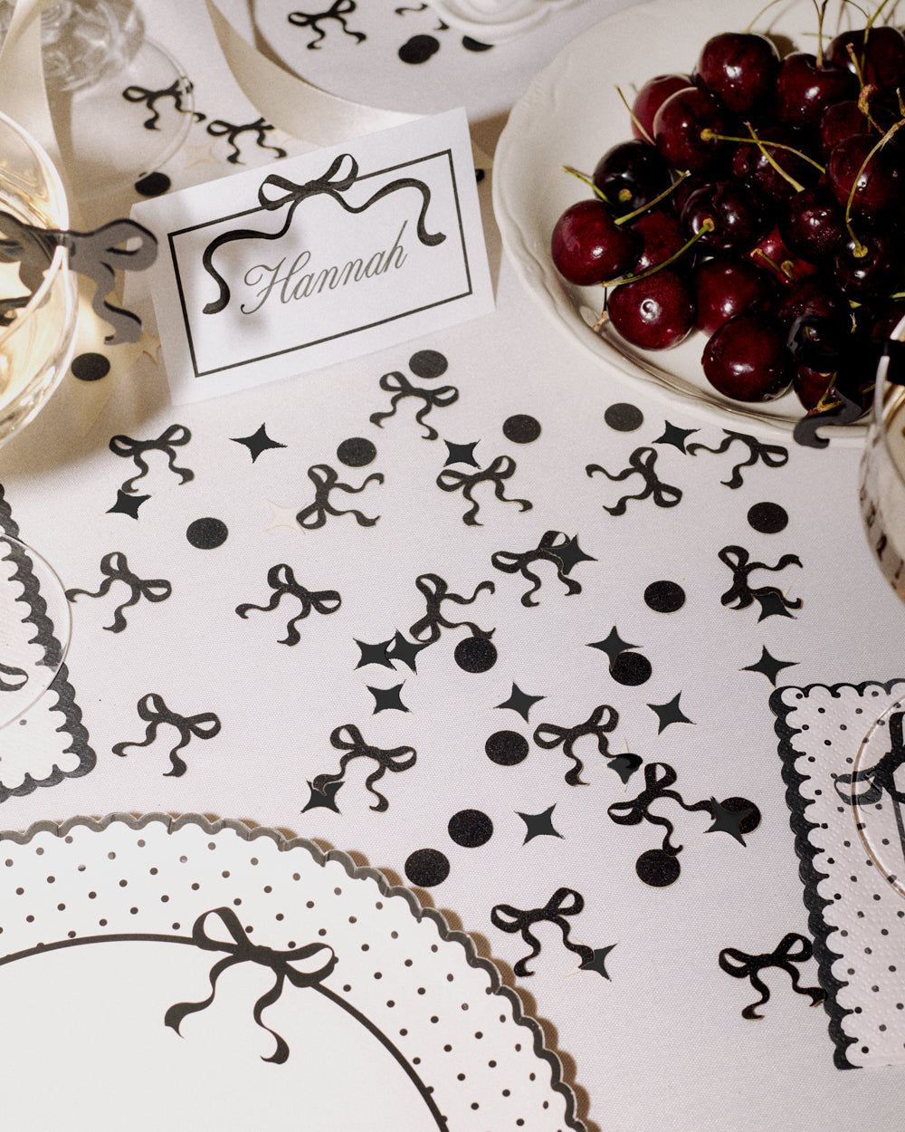 Decorative table setting with black and white patterns on a white tablecloth.