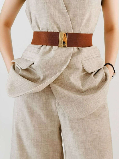 Beige jumpsuit with a brown belt on a plain background