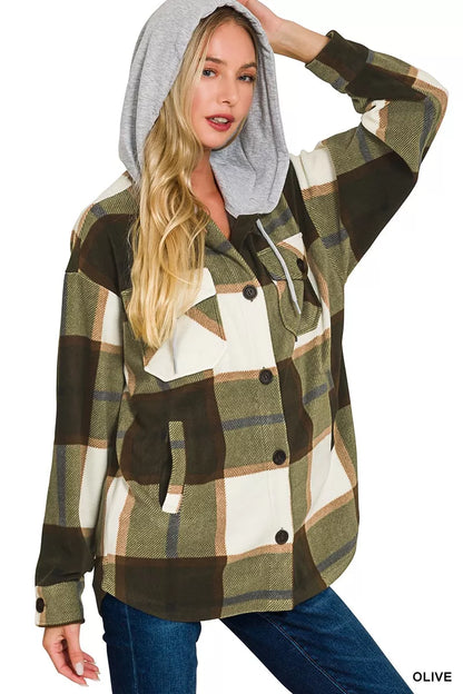 Woman wearing a plaid jacket with a hood on a white background