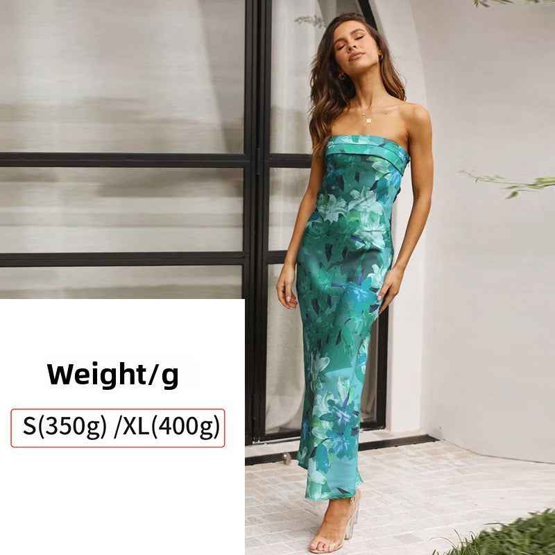 Satin strapless backless midi dress with a floral pattern in shades of green, featuring a side slit.