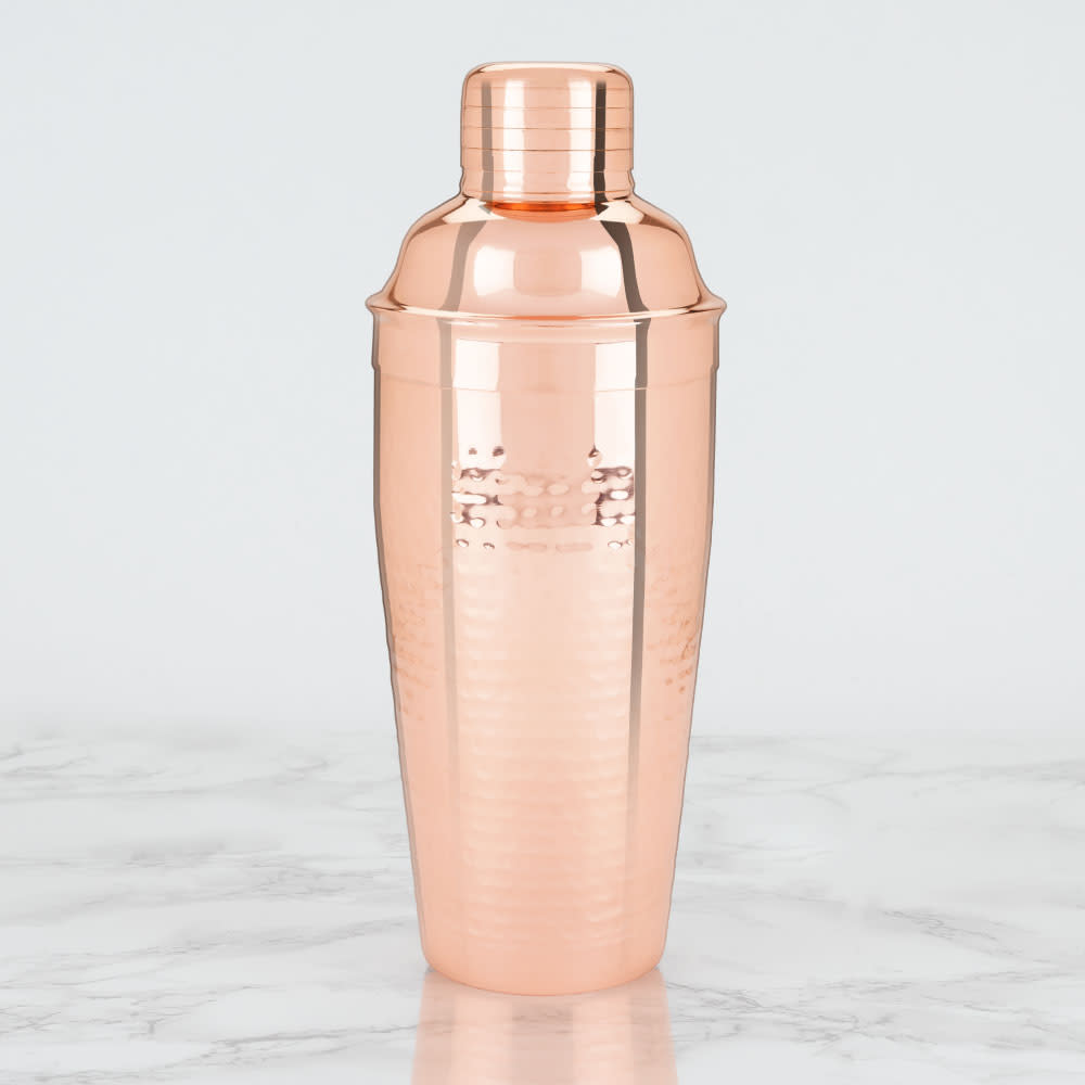 Rose gold cocktail shaker on a marble surface