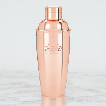 Rose gold cocktail shaker on a marble surface