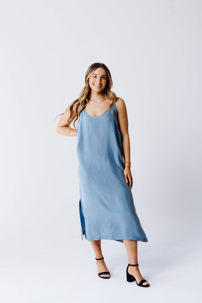 Woman wearing a blue dress on a white background