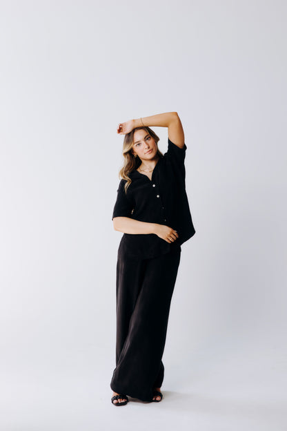 Woman wearing a black outfit on a white background