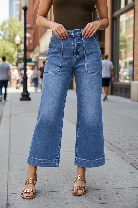 Blue jeans worn by a person on a city sidewalk