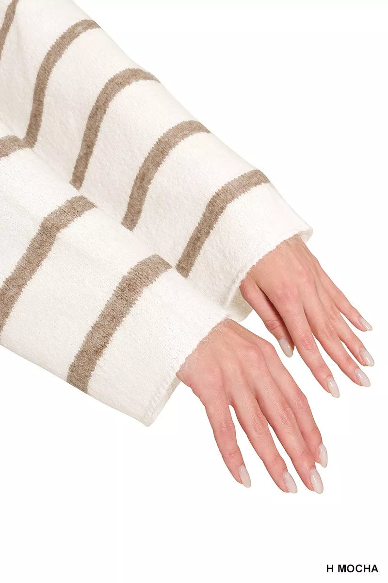 close up of sweater arm length.  woman with her arms outstretched showing the length of the sweater arms.