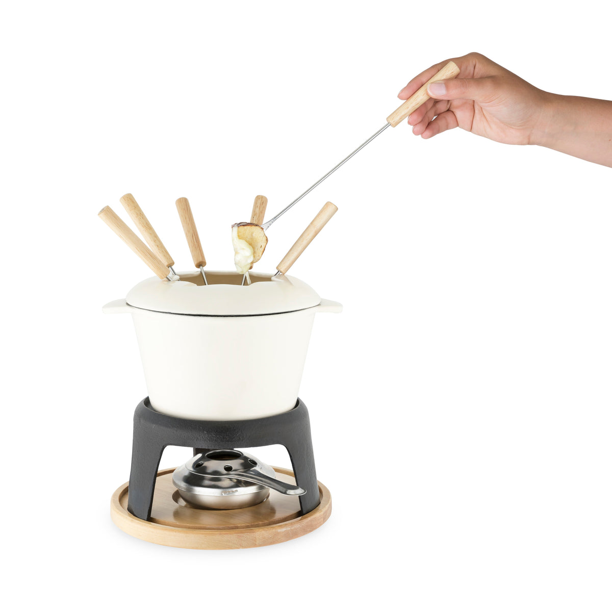 Fondue set with a hand using a fondue fork to dip food into the melted cheese.