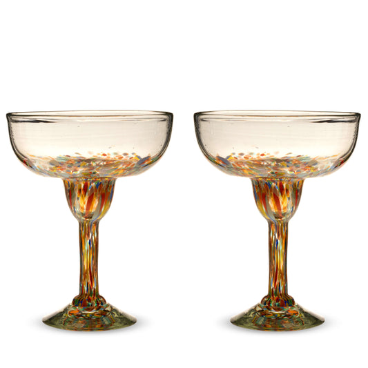 Two empty Segunda Vida Artistico margarita glasses with multicolored speckles in the bowls, stems, and bases.